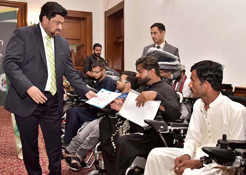 Governor Sindh Kamran Khan Tessori addressing during Prime Minister Electric Wheel Chairs Scheme distribution ceremony for the differently abled university students at Governor House