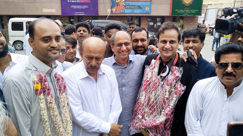 PPP Sindh President Nisar Khuhro presents sweets to Mayor-elect Murtaza Wahab on his victory at Arts Council.