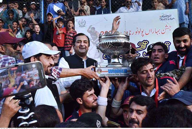 Chief Minister Gilgit-Baltistan Khalid Khurshid Khan giving away winner trophy to team captain of GB Scouts during prize distribution ceremony of Jashn-e-Baharan Freestyle Polo Tournament at Aga Khan Shahi Polo Ground