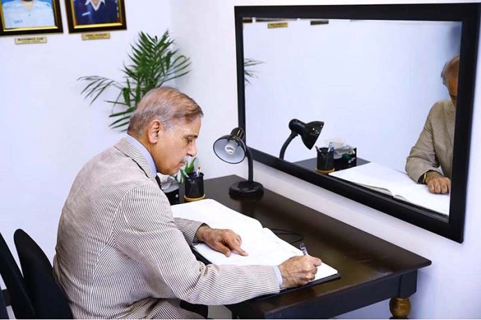 Prime Minister Muhammad Shehbaz Sharif penning down his views in the Yadgar-r-Shuhada in Police Lines Headquarters