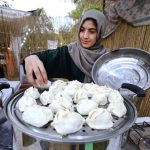 A girl from Gilgit-Baltistan preparing dumpling (a traditional dish locally called Mantu) during Saqafati Mela at Lok Virsa