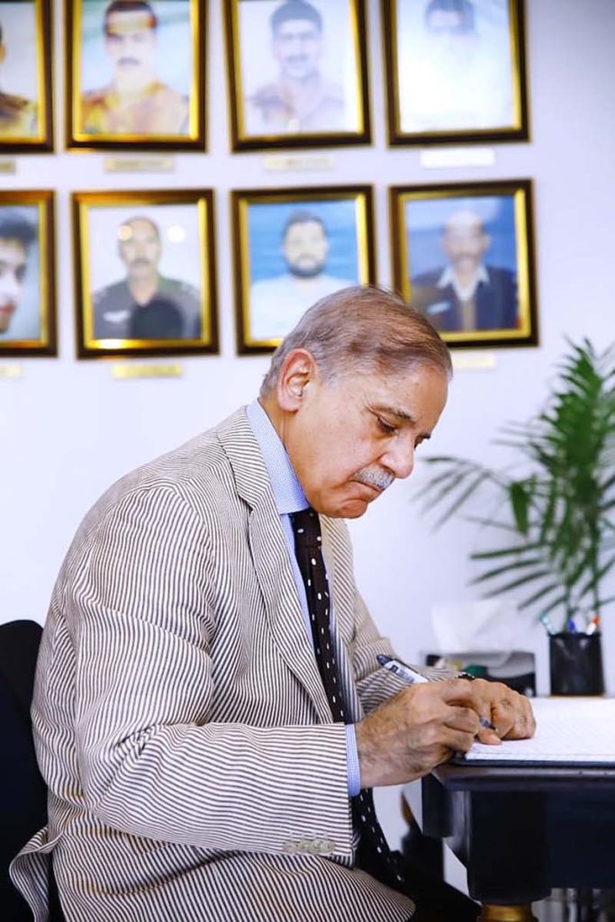 Prime Minister Muhammad Shehbaz Sharif penning down his views in the Yadgar-r-Shuhada in Police Lines Headquarters