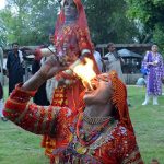 A folk artist from Cholistan blowing fire from mouth during Saqafati Mela at Lok Virsa