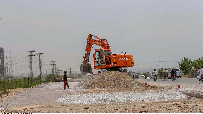 Heavy machinery being used to expand lanes for smooth traffic on Islamabad Expressway