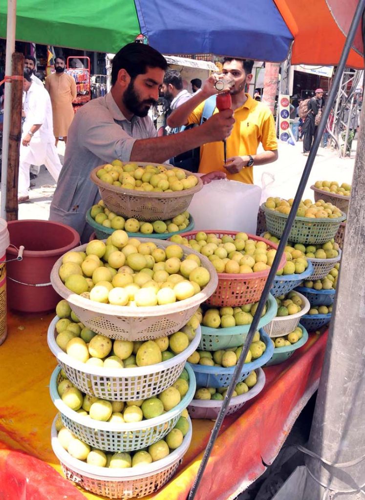 A vendor selling summer drink lemonade at his roadside setup in the Federal Capital