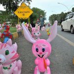 Street vendor selling colorful balloons at a roadside