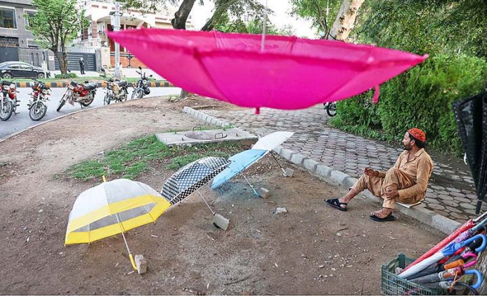 A vendor displaying umbrellas to attract the customers at F-6/1 in Federal Capital