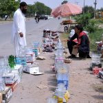 A vendor selling crockery at his roadside setup in the Federal Capital