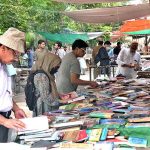 People busy in selecting and purchasing old books from roadside stall in Provincial Capital