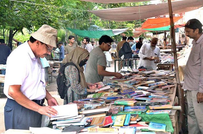 People busy in selecting and purchasing old books from roadside stall in Provincial Capital