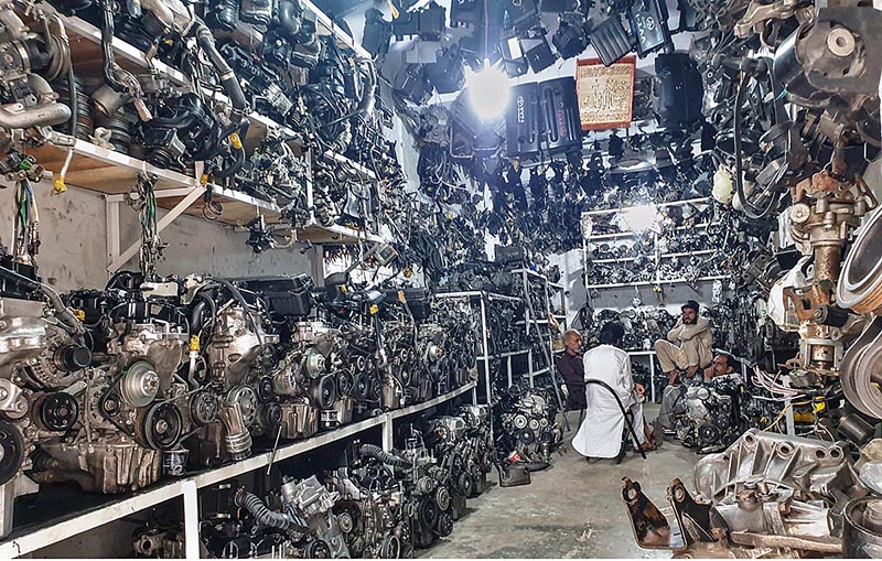 Vendors displaying old vehicles' engines to attract the customers in shop at Chah Sultan