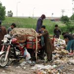 Gypsy boys searching valuables from garbage near Khanna Pul area in the Federal Capital