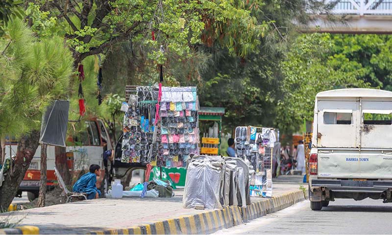 A view of encroachment displaying different kinds of stuff at footpath creating problems for pedestrians at Double Road