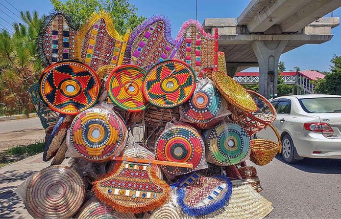 A street vendor displaying different kinds of household stuff to attract customers at Shamsabad