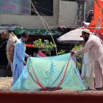 A customer busy in selecting and purchasing mosquitoes net from a vendor at Pirwadhai