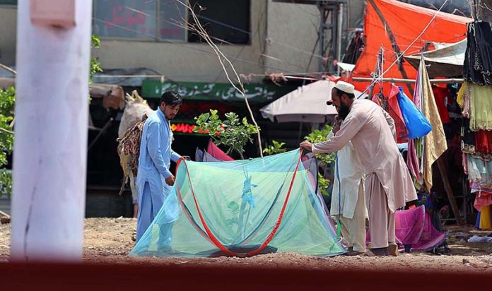 A customer busy in selecting and purchasing mosquitoes net from a vendor at Pirwadhai