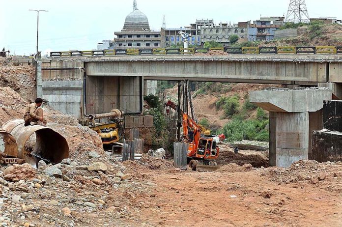 Heavy machinery being used at the site of a collapsed bridge near Lahore High Court (Rawalpindi Bench) at Swan in the outskirts of the city
