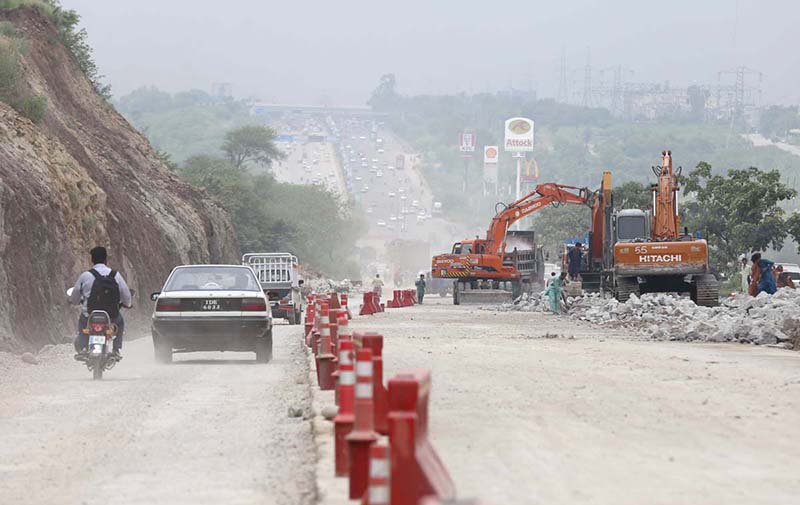 Heavy machinery being used to build new lanes on Islamabad Expressway