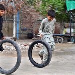 Youngsters playing with old motorcycle tyres at Tewana Park
