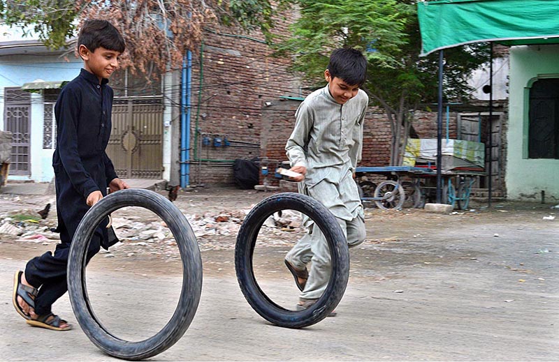 Youngsters playing with old motorcycle tyres at Tewana Park