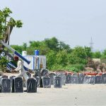 A vendor displaying window shades of cars to attract customers on Islamabad Expressway
