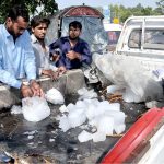 A vendor sells Ice in a hot day on his truck setup