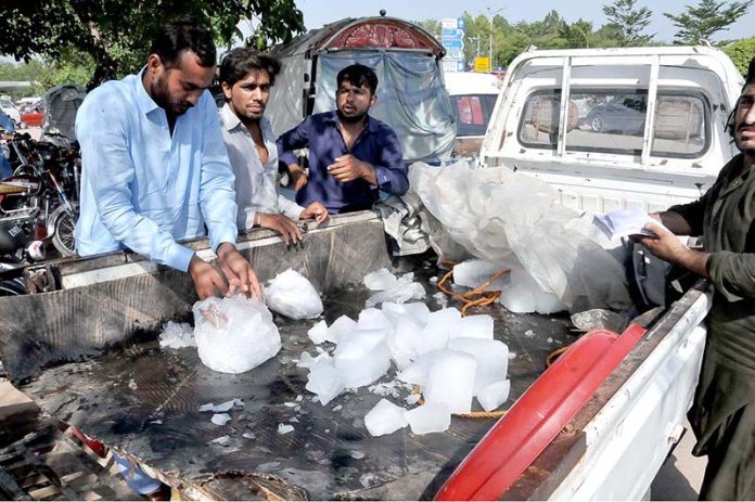 A vendor sells Ice in a hot day on his truck setup
