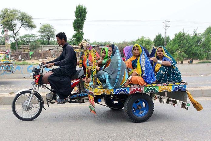 Villager women are traveling on the tricycle rickshaw heading towards their destination Villager women are traveling on the tricycle rickshaw heading towards their destination