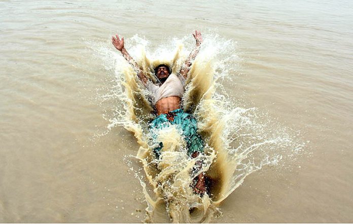 Youngsters jumping and bathing in Rice Canal to get relief from scorching hot weather
