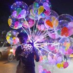 A vendor displaying colorful balloons to attract the customers at Latifabad