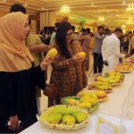 Girls viewing the displayed various varieties of mangoes during three days of ''Mango Festival 2023'' at Arena Hall DHA