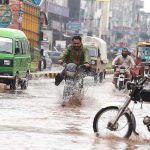 A view of rain water accumulated on the roads after rainfall causing difficulties for the commuters