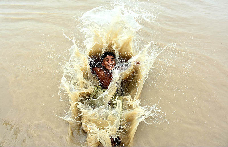 Youngsters jumping and bathing in Rice Canal to get relief from scorching hot weather