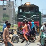 Dangerous moment as a motorcyclists crossing railway track while the train is approaching at makki shah area
