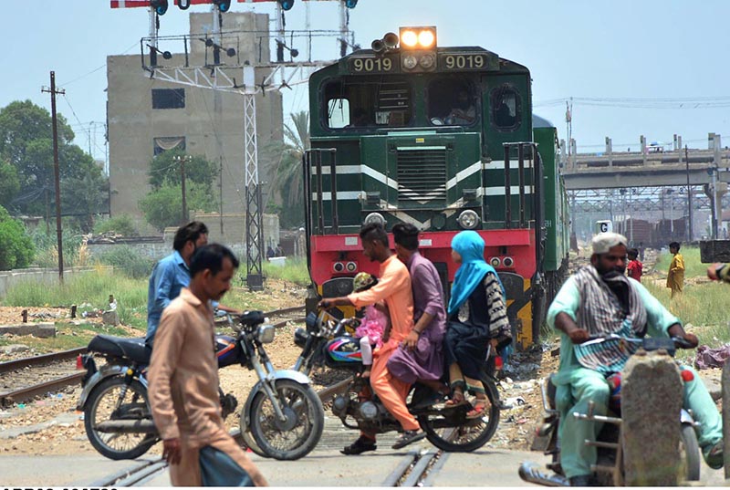 Dangerous moment as a motorcyclists crossing railway track while the train is approaching at makki shah area
