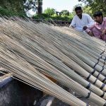 A vendor selling brooms at his roadside setup in Melody to earn some livelihood