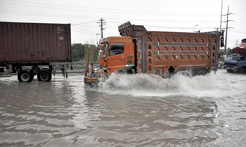 A motorcyclist passing through rain water accumulated on the IJP Road during heavy rain