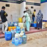 People busy in filling water cane from filter plant at Latifabad.