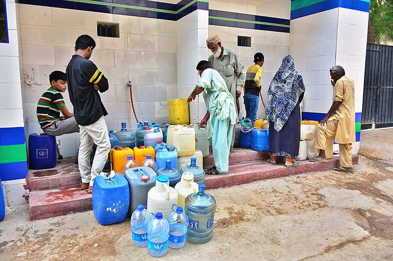 People busy in filling water cane from filter plant at Latifabad.