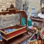 A vendor arranging and displaying the Muharram related stuff during the Holy Month of Muharramul Harram