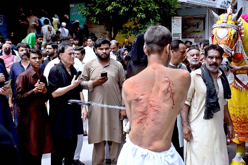 Shiite Muslims flagellate themselves with knifes on chains during the 10th Muharram procession to mark Ashoura. Ashoura is the commemoration marking the Shahadat (death) of Hussein(AS), the grandson of the Prophet Muhammad(PBUH), with his family members during the battle of Karbala for the upright of Islam