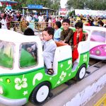 Children enjoying the mechanical swing ride at Fun Land Park