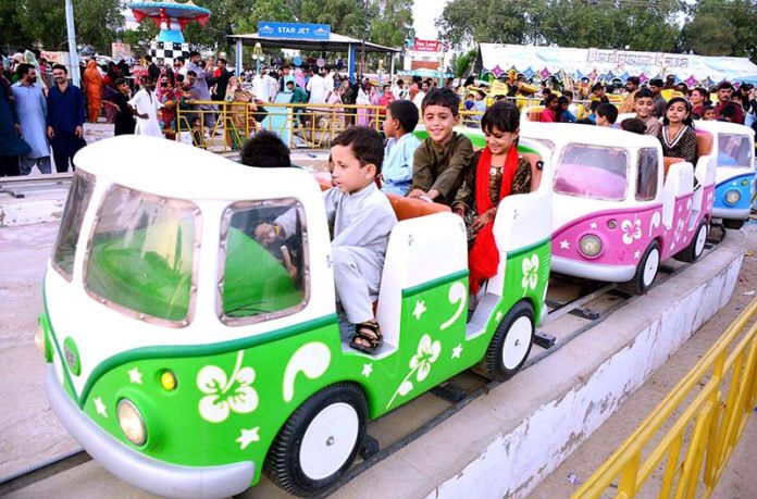 Children enjoying the mechanical swing ride at Fun Land Park