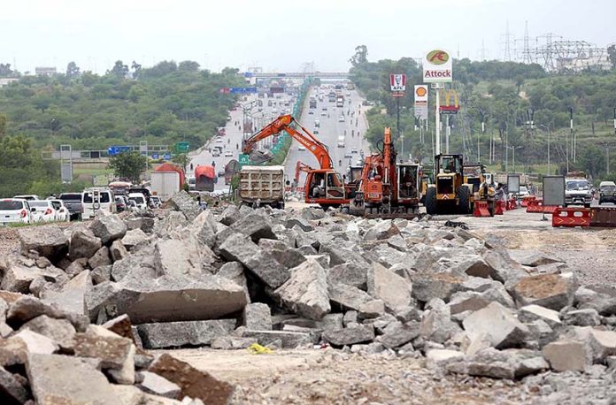 Heavy machinery being used to expand Islamabad Expressway during development in Federal Capital