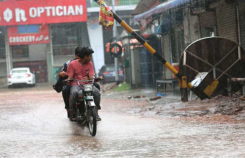 A view of rain water accumulated on the roads after rainfall causing difficulties for the commuters