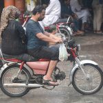 A family traveling during heavy rainfall in the city