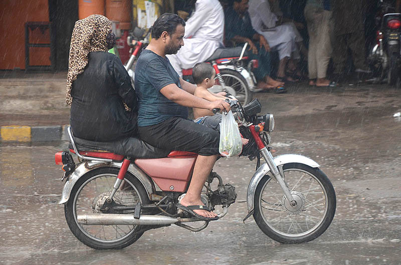 A family traveling during heavy rainfall in the city