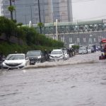 Vehicles crossing flooded water after heavy rain that experience in the provincial capital