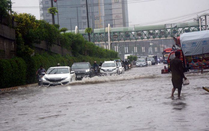 Vehicles crossing flooded water after heavy rain that experience in the provincial capital