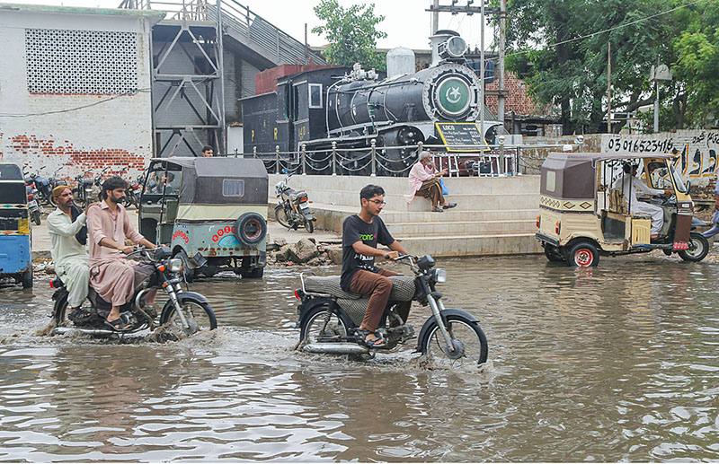 Rain water accumulated on the road at Latifabad